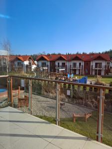 a view of a park with houses in the background at Apartament Piaskowa 2 in Żarnowska