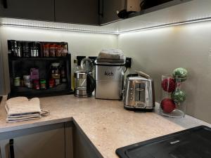 a kitchen counter with a coffee maker and a toaster at Luxury Retreat in Embsay