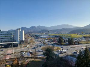 a city with cars parked in a parking lot at ONYX - Vision Aparthotel in Braşov