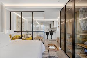 a bedroom with a bed and a living room at Golden Mile Lux Sea View Suite with Balcony in Marbella +28 photos