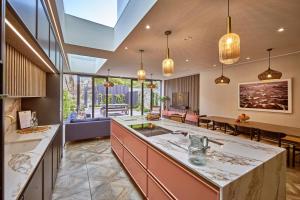 an open kitchen with a large island and a living room at Saltrock House - Portrush in Portrush