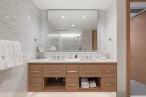 a bathroom with a sink and a large mirror at Snowmass Lux Getaway by Snowmass Vacations in Snowmass Village +33 photos