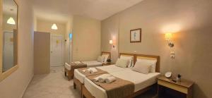 Postel nebo postele na pokoji v ubytování Koulouris Beach Hotel