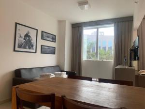 a living room with a table and a couch at Hotel Condominio Barretos Park Hotel in Barretos