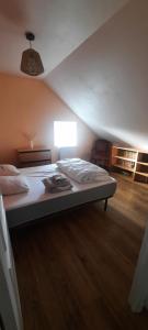 a bedroom with a large bed with a light on it at La petite maison de Chavroches - proche du Pal in Chavroches