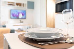 a table with a bowl and a glass of wine at NINO-Boardinghouse 20 in Nordhorn