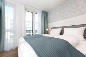a bedroom with a bed and a large window at NINO-Boardinghouse 20 in Nordhorn +13 photos
