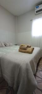 a pair of towels sitting on top of a bed at Urbano B&B 4A in San Juan