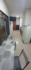 a room with a kitchen with a table and a refrigerator at Urbano B&B 4A in San Juan