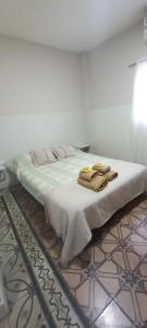 a bed with two towels on top of it at Urbano B&B 4A in San Juan