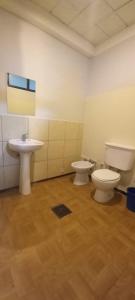 a bathroom with two toilets and a sink at Urbano B&B 4A in San Juan