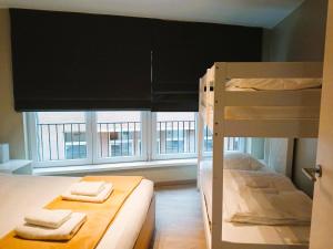 two bunk beds in a room with a window at EasyEscape - Martha-Louise in Blankenberge