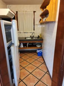 a small kitchen with a sink and a tiled floor at Brisas del Lago in San Carlos de Bariloche +29 photos