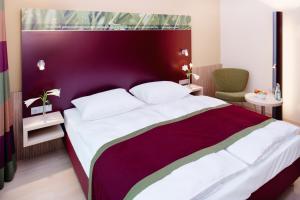 Een bed of bedden in een kamer bij Mövenpick Hotel Frankfurt City