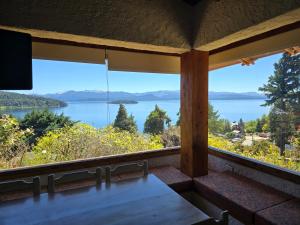 a view of a lake from the porch of a house at Brisas del Lago in San Carlos de Bariloche