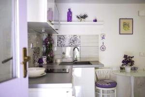 a kitchen with a sink and a counter top at House Marie?s Lavander Dream in Raslina +18 photos