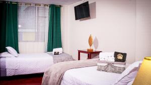 Postel nebo postele na pokoji v ubytování UKUKU Hostel