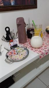 a counter with a plate of food on a table at Suítes da Penha in Capitólio +15 photos