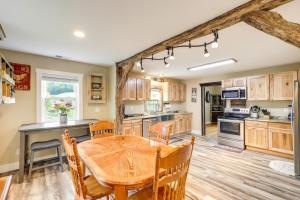 a large kitchen with a wooden table and chairs at Hike and Relax Blue Ridge Mountain Retreat! in Burnsville