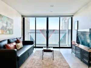 a living room with a couch and a table at Dowtown 1 BR Suite in Av Revolucion Tijuana in Tijuana