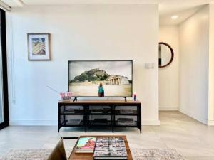 a living room with a flat screen tv on a wall at Dowtown 1 BR Suite in Av Revolucion Tijuana in Tijuana