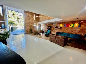 a living room with a table and a brick wall at Hotel Toscana Oriente in Rionegro