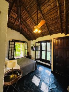 a bedroom with a bed in a room with windows at Posada Morotí in Esquina +39 photos