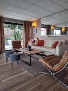 a living room with a couch and a table at Hôtel Le Collier in Antibes +94 photos