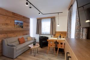 salon z kanapą i stołem w obiekcie Ella's w mieście Fusch an der Großglocknerstraße