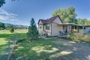 a small house with a fence in a field at Modern Cortez Mountain Retreat with Yard and View in Cortez