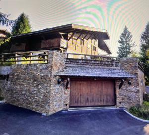 a brick building with a garage with a wooden door at Confort et Proximité in Megève +19 photos