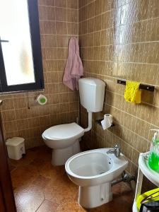 a bathroom with a toilet and a sink at Villaliana in Torre Dei Corsari +66 photos