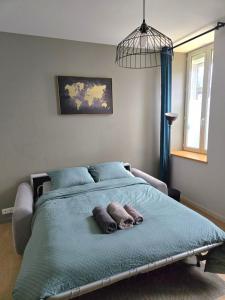 a bedroom with a bed with two pillows on it at Studio du Pont Tournant in Cherbourg en Cotentin