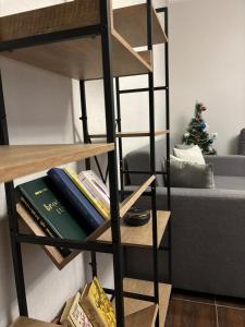 a book shelf with books on it next to a couch at GUEST HOUSE IN Dilijan MD GUEST HOUSE in Dilijan