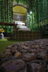 a room with rocks in the middle of a room with plants at Azcami Boutique Hotel in Puebla