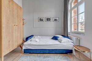 Posteľ alebo postele v izbe v ubytovaní Apartments Waterlane Vintage & by Noclegi Renters