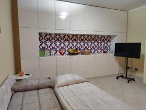 a living room with a couch and a flat screen tv at Il Melograno in Terzigno