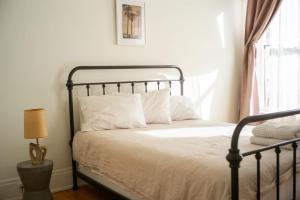 a bedroom with a bed with white sheets and a window at Object Hotel 2BR Room 2B in Bisbee