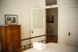 a bedroom with a bed and a dresser and a door at Object Hotel 2BR Room 2B in Bisbee +26 photos