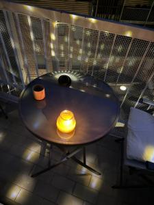 a round table with a yellow candle on top of it at Milano Duomo Design Apartment in Milan