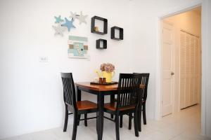 a dining room with a table and two chairs at Tangerine Sunsets Skylark in Nassau