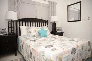 a bedroom with a bed with a blue star on it at Tangerine Sunsets Skylark in Nassau