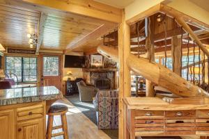 a log cabin with a spiral staircase in a living room at Less Than 1 Mi to Lake Tahoe Beaches Home with Fire Pit! in Tahoe City