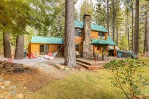 a log cabin with a hammock in the woods at Less Than 1 Mi to Lake Tahoe Beaches Home with Fire Pit! in Tahoe City