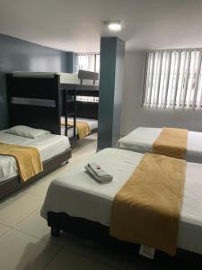 Postel nebo postele na pokoji v ubytování Hotel Escorial Ibagué