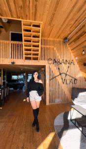 a woman is standing in the middle of a room at Cabana Vlad Maramureș in Deseşti +86 photos
