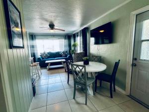 a dining room and living room with a table and chairs at Playa Esmeralda INN unit #1 in Bradenton Beach