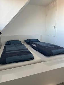 a bed with two pillows on it in a room at Cozy 2 bedroom apartment in Maarssen