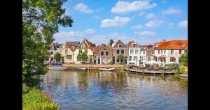 a group of houses and boats on a river at Cozy 2 bedroom apartment in Maarssen