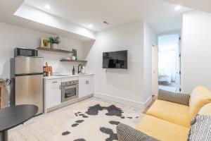 a kitchen and living room with a couch and a refrigerator at Luxury DuPont Apartment in the heart of DC in Washington +7 photos